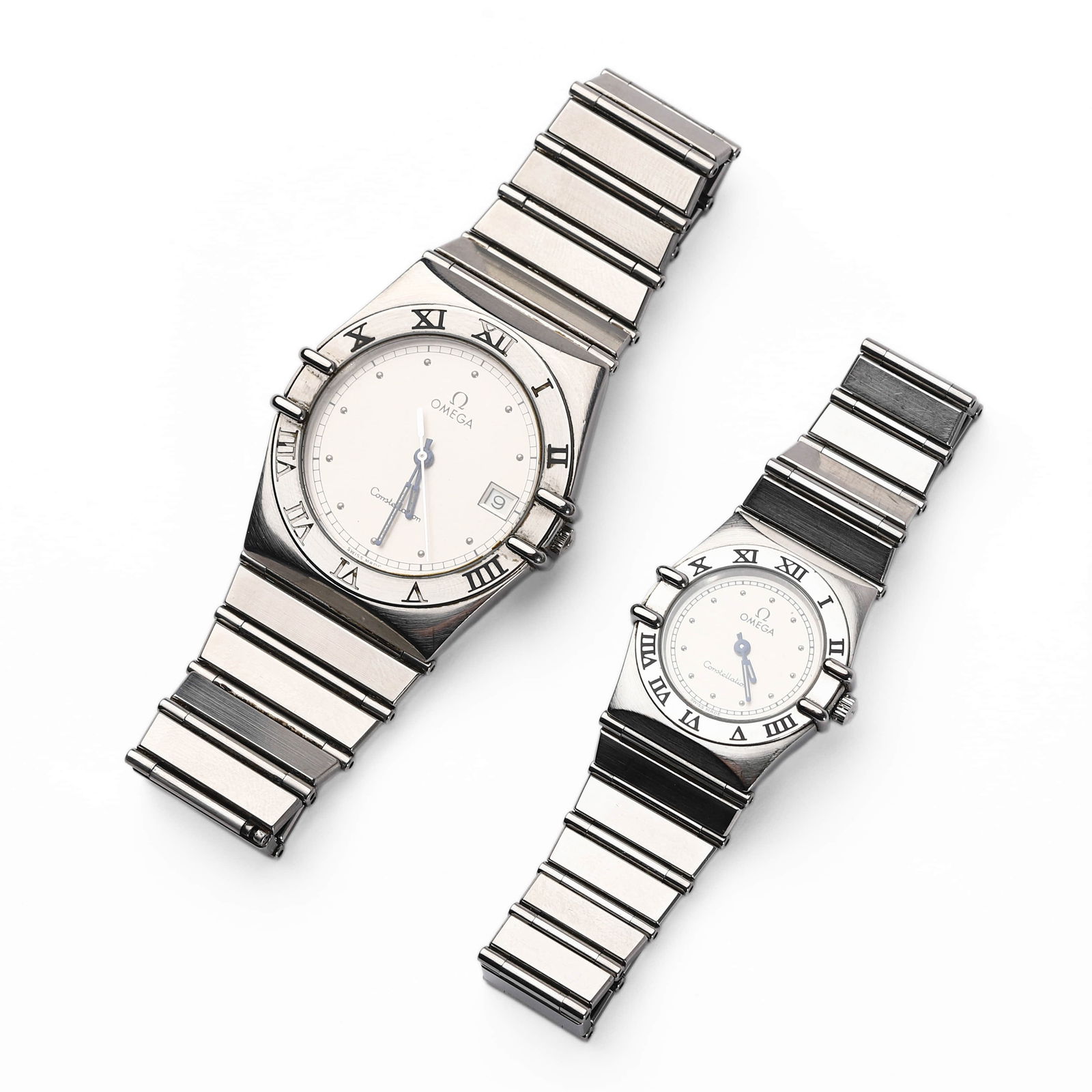 PAIR OF OMEGA CONSTELLATION STAINLESS STEEL QUARTZ WRISTWATCHES: Dimensions Gents: Dial diameter 1 5/16 in. (33.7 mm)Ladies: Dial diameter 31/32 in. (24.5 mm) Description A matching pair of Omega Constellation wristwatches in stainless steel, each with a white