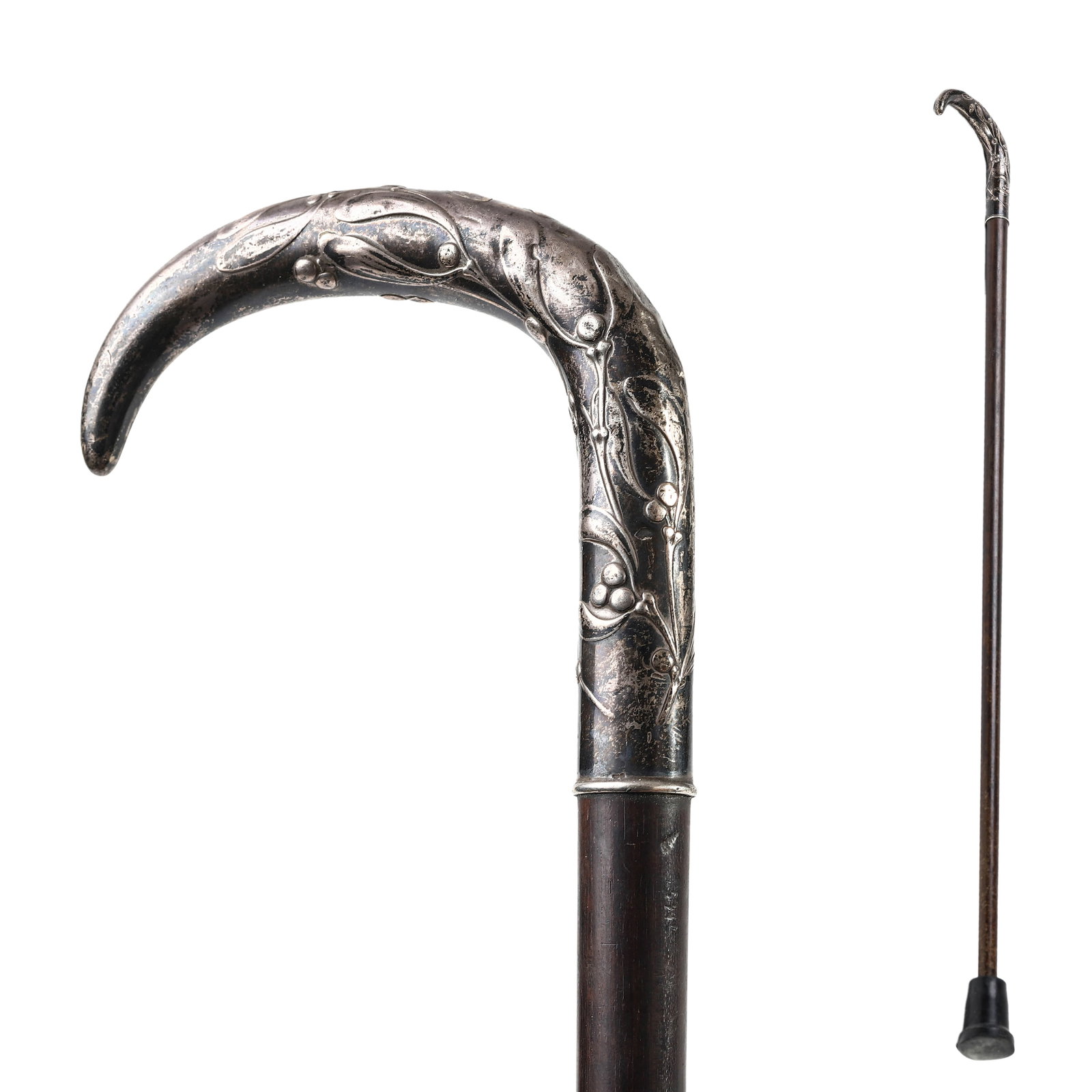 ART NOUVEAU SILVER-HANDLED WALKING CANE WITH MISTLETOE MOTIF: Dimensions: Length: 31 11/16 in. (80.5 cm) Description: This elegant walking cane features a finely crafted silver handle richly embossed with an Art Nouveau mistletoe motif, symbolizing peace and pro