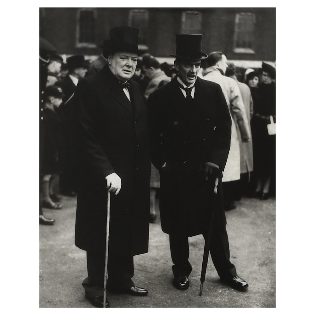 WINSTON CHURCHILL AND NEVILLE CHAMBERLAIN, GROUP PORTRAIT: Title WINSTON CHURCHILL AND NEVILLE CHAMBERLAIN, GROUP PORTRAIT Medium Gelatin silver photograph, mounted on board Signature Signed in black ink on the lower left of the photograph Dimensions Photogra