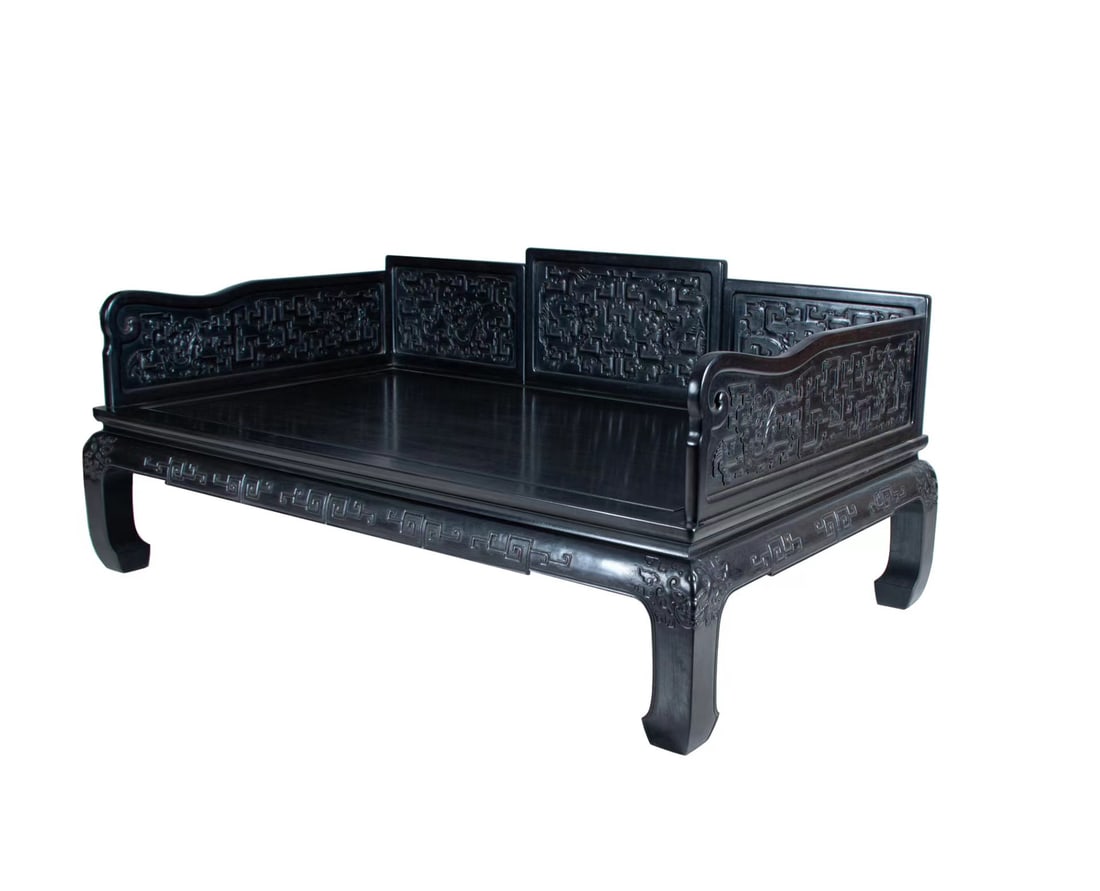 A Chinese Zitan Luohan Bed with Relief-carved Guai Zi Dragon Patterns: L:210cm W: 126cm H?95cm This stately luohan bed is constructed in a three-panel screen form, with the central back panel as the tallest, flanked by two shorter side panels and two curved armrests, cre