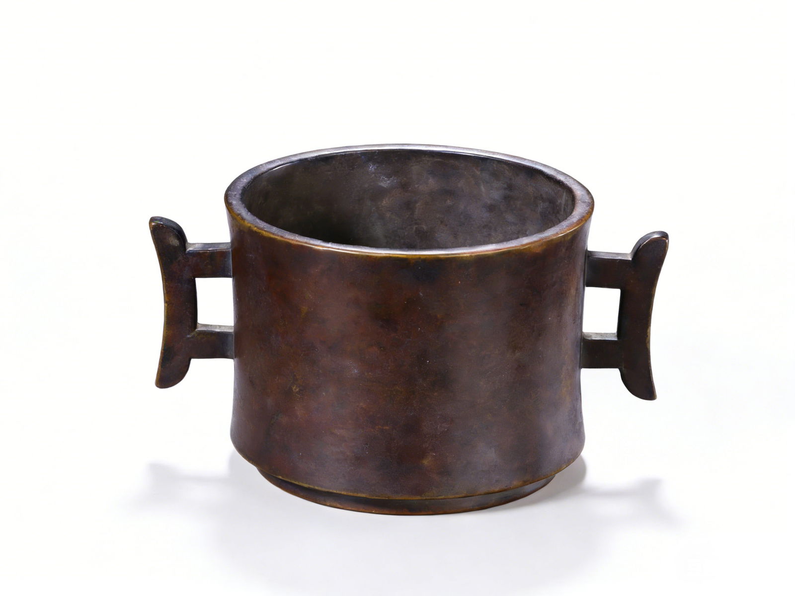 A Fine Ming Bronze Cylindrical Censer with Halberd Handles: H?8.7cm W:16cm Weight:1191g This elegant censer is masterfully cast from bronze in the Ming Dynasty, with a cylindrical body and a flared rim. The sides are adorned with two symmetrical halberd-shaped