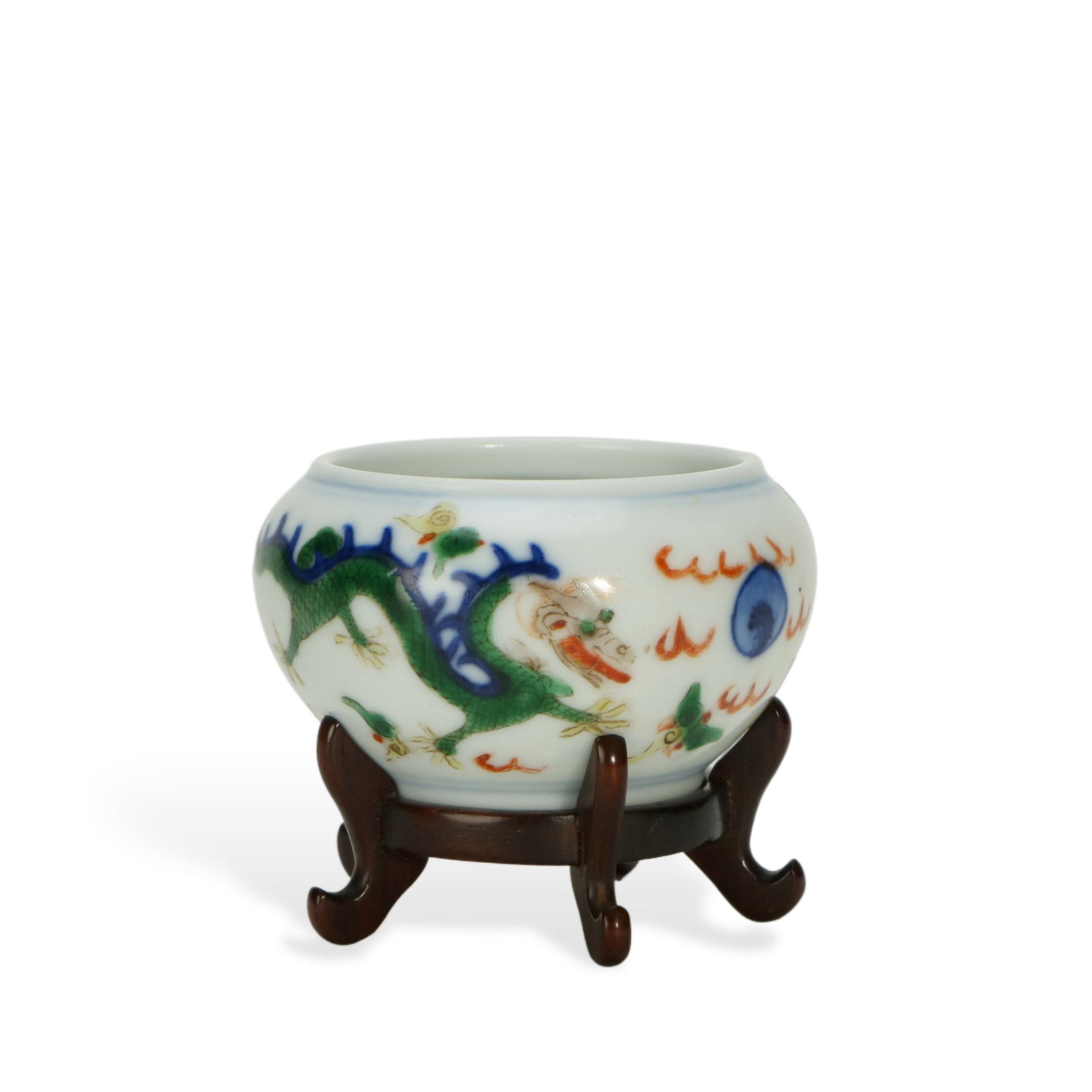 Small Wucai Water Pot with Dragon Patterns (with Redwood Stand): H:3cm W:6cm This is a small Wucai water pot with dragon patterns, equipped with a redwood stand. The water pot has a small and round shape, and the body is delicate. The dragon pattern is painted