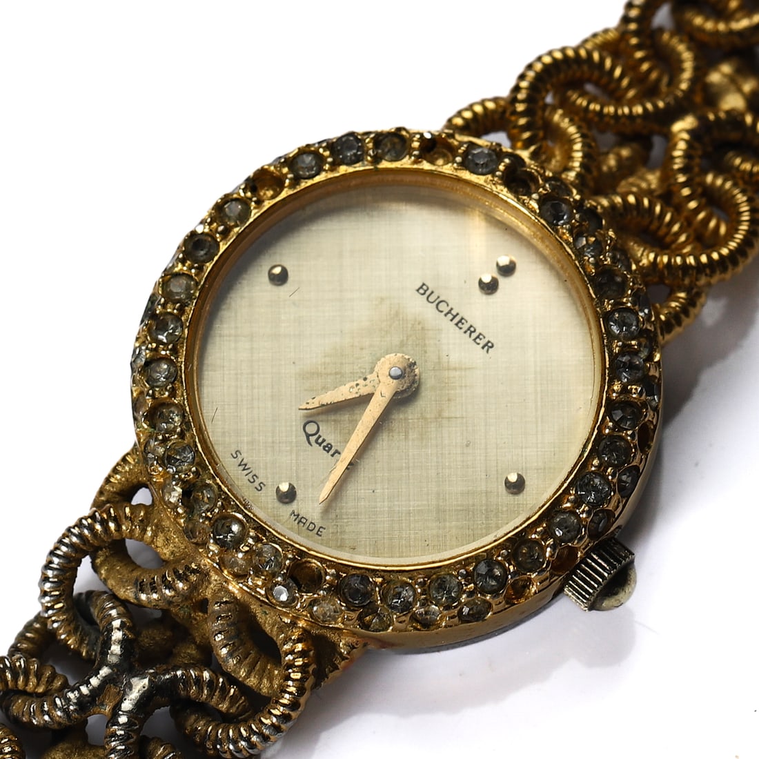 BUCHERER QUARTZ WRISTWATCH: Dimensions Length: 6 11/16 in (17 cm); Diameter: 7/8 in (22.4 mm) Description A gold-tone Bucherer quartz wristwatch with round case and champagne dial, signed “Bucherer” and