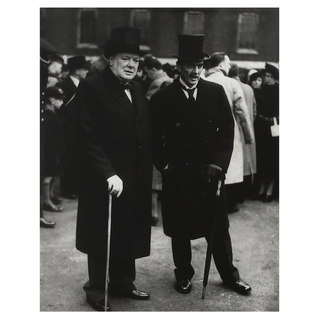 WINSTON CHURCHILL AND NEVILLE CHAMBERLAIN, GROUP PORTRAIT: Title WINSTON CHURCHILL AND NEVILLE CHAMBERLAIN, GROUP PORTRAIT Medium Gelatin silver photograph, mounted on board Signature Signed in black ink on the lower left of the photograph Dimensions