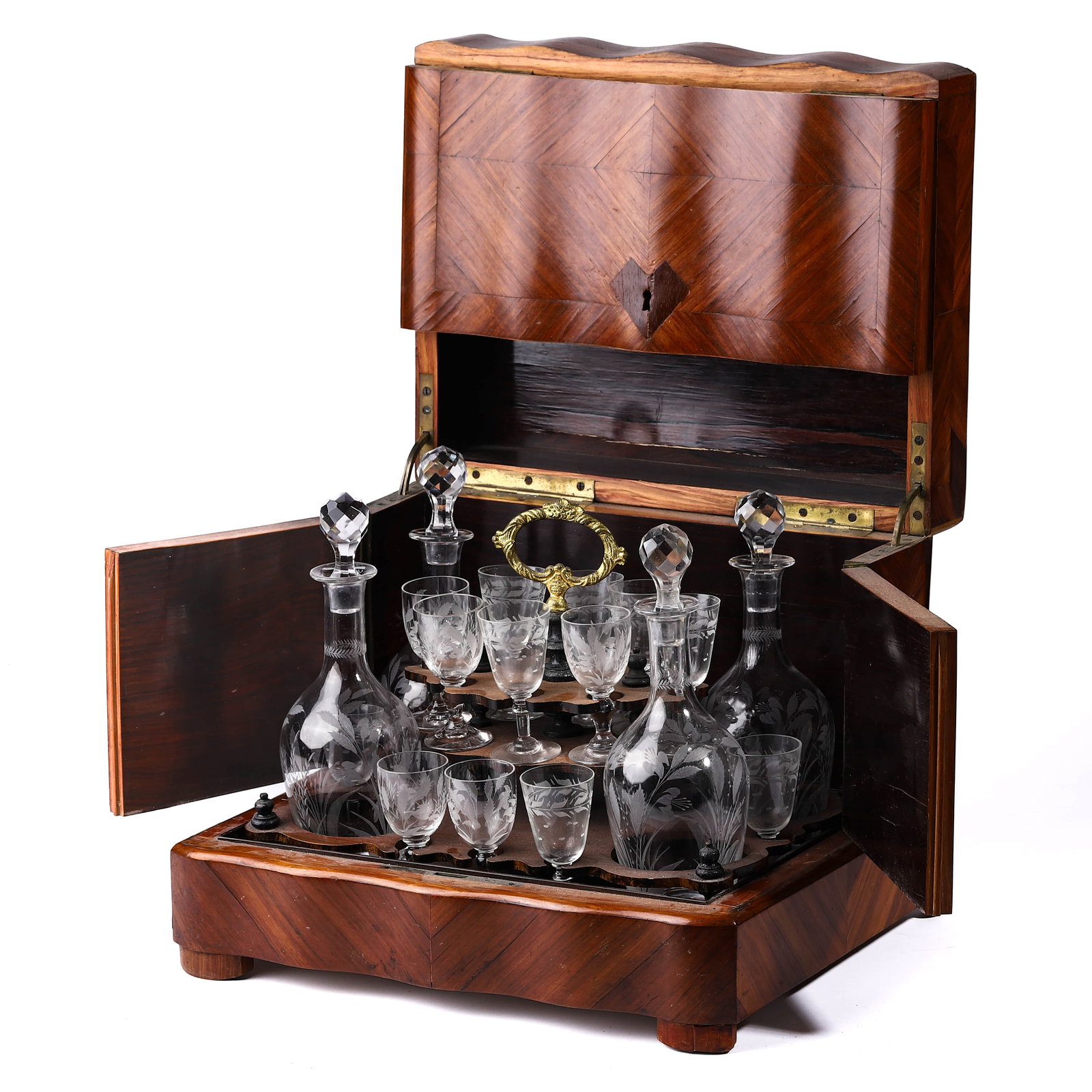 A FRENCH ETCHED GLASS LIQUEUR CASKET SET, WITH MAHOGANY CASE.: Dimensions: Height of decanters: 7 7/8 in. (20 cm) This elegant French liquor cabinet includes four crystal decanters with faceted stoppers and sixteen etched cordial glasses arranged in a removable