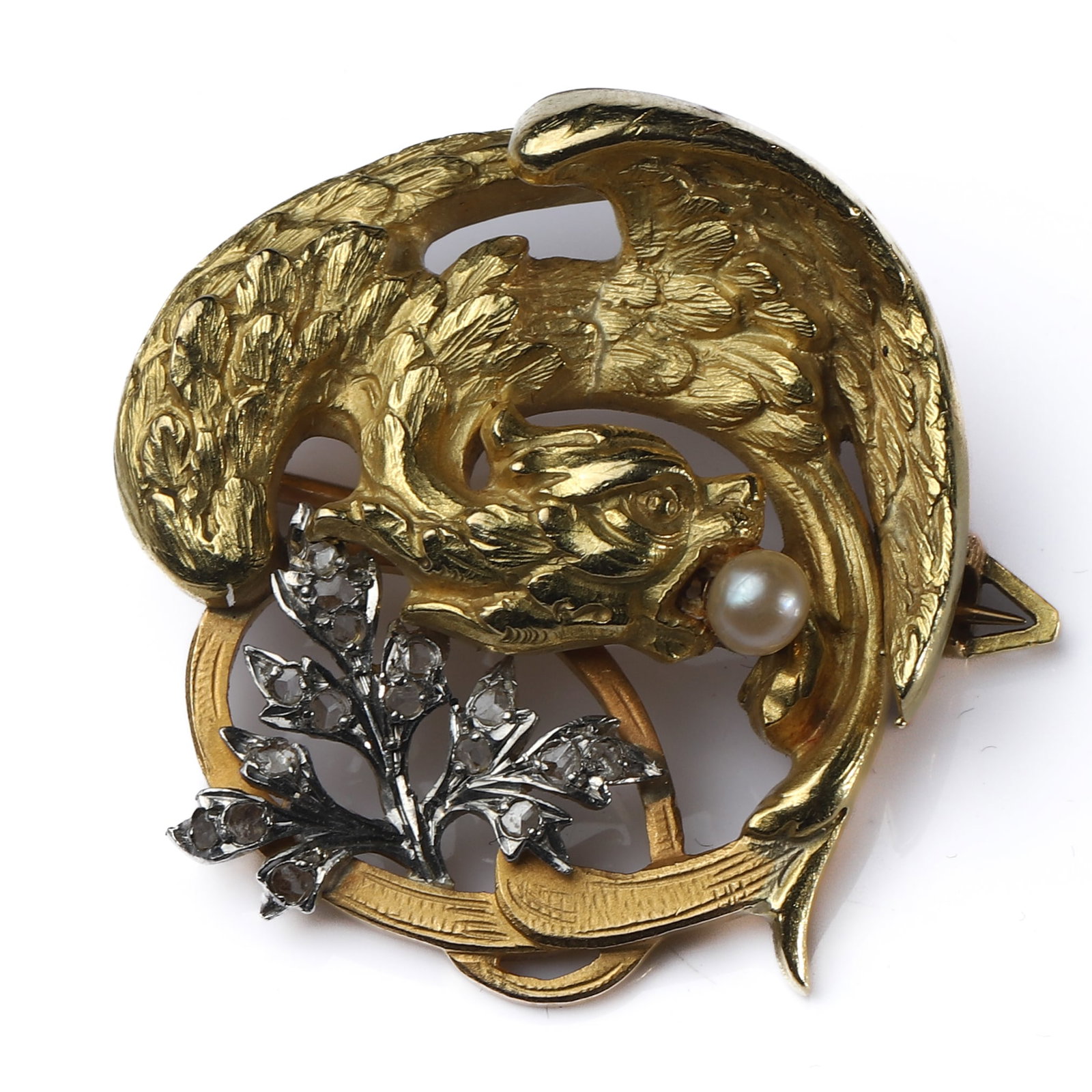 AN EDWARDIAN FRENCH GOLD, PLATINUM, DIAMOND AND PEARL CHIMERA BROOCH: Dimensions Length 1 1/4 in. (3.2 cm), Width 1 3/16 in. (3 cm)Weight: 8.9 g Description An Edwardian period (1901–1910) French brooch, finely handcrafted in 18K gold, designed as a sculptural