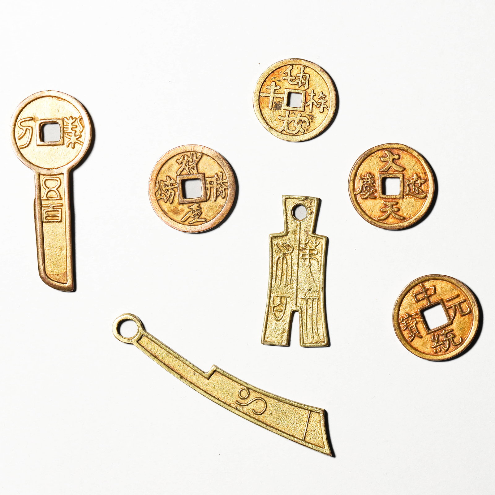 A GROUP OF GILT-BRONZE COINS.: Length 3 1/8 in (8 cm)