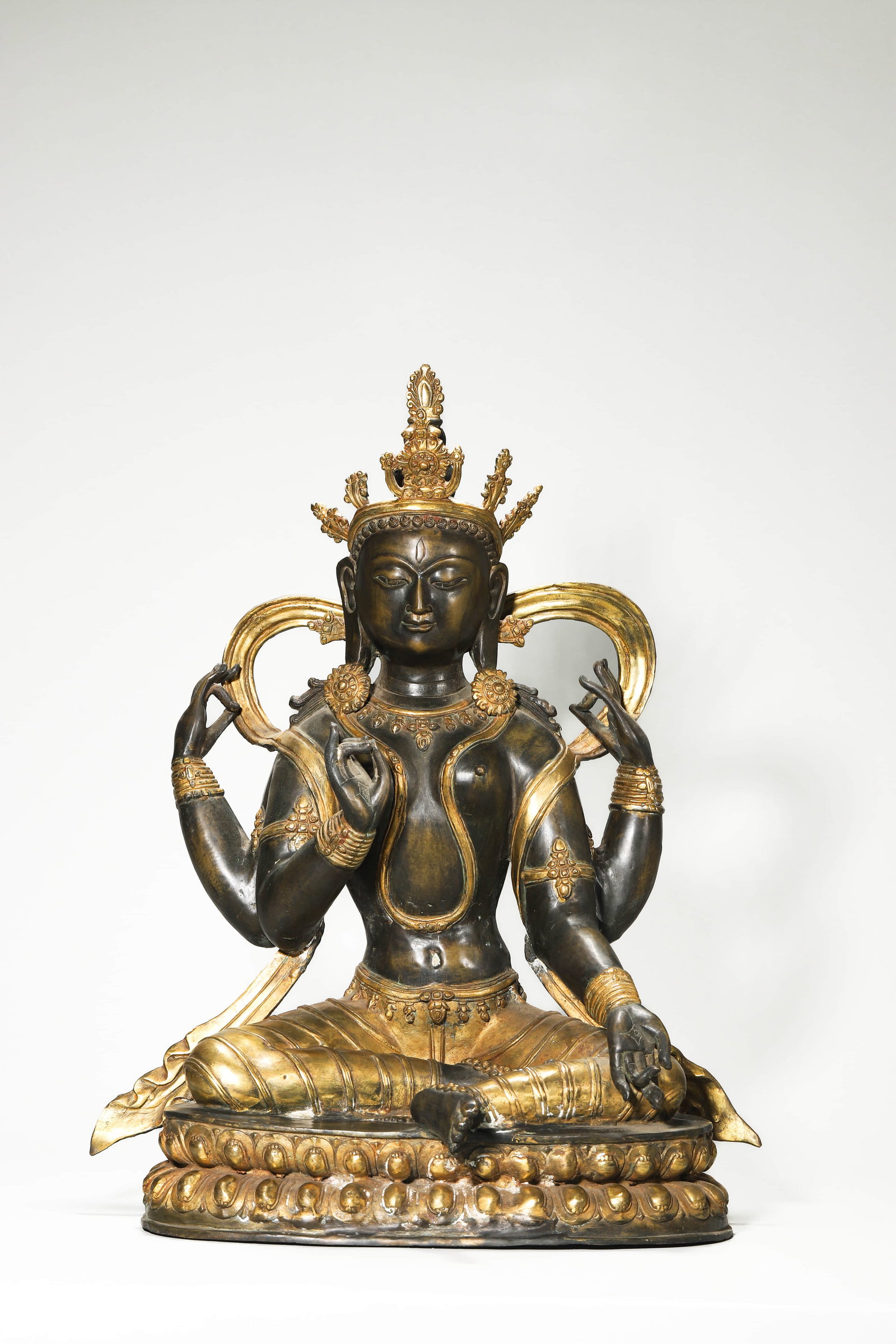A GILT-BRONZE FOUR-ARMED GUANYIN.: Height 20 1/16 in (51 cm)