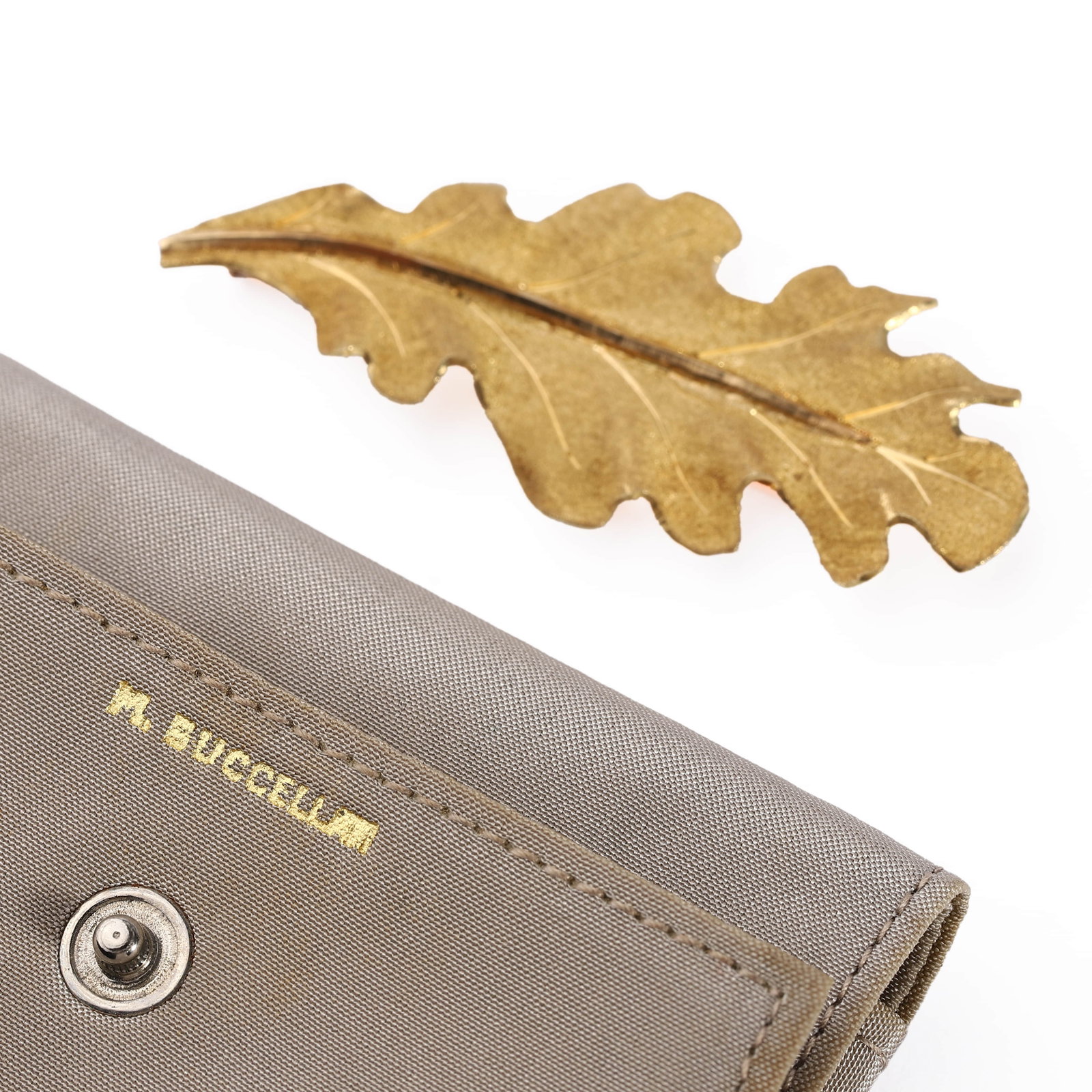 18K GOLD OAK LEAF BROOCH BY M. BUCCELLATI: Dimensions: Length: 2 1/16 in. (53 mm), Width: 7/8 in. (22 mm), Weight: 8.12 g This finely crafted brooch by Mario Buccellati is designed as an oak leaf and executed entirely in 18K yellow gold. A