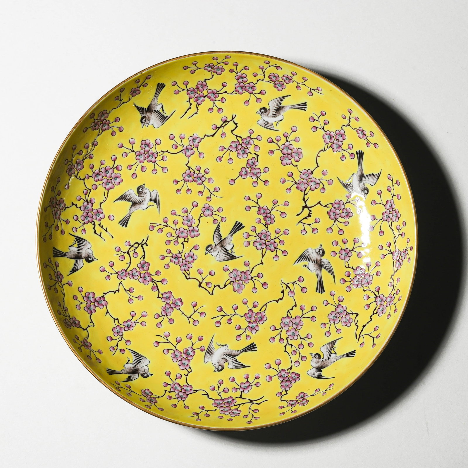 TONGZHI MARK, A YELLOW-GROUND “MAGPIE AND PLUM BLOSSOM?? DISH, MARKED “TONGZHI NIAN ZHI,: Diameter 8 1/16 in (20.5 cm)