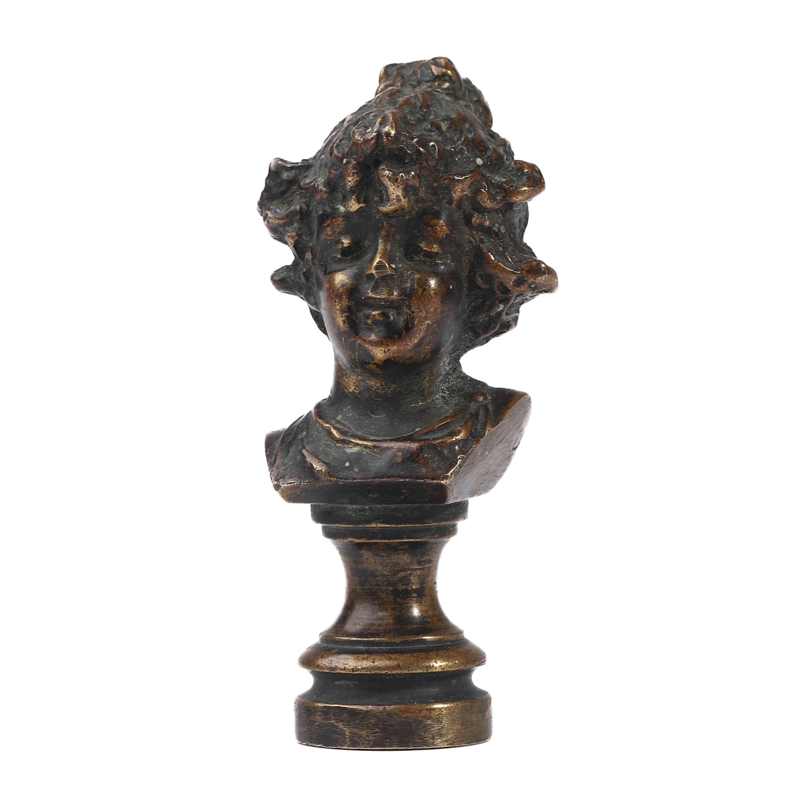 BRONZE BUST SEAL OF A YOUTH: Dimensions Height 2 7/8 in (7.4 cm); Weight 209.4 g. Description A solid bronze seal featuring the expressive bust of a youthful figure with voluminous, curly hair and lively facial features. The bust