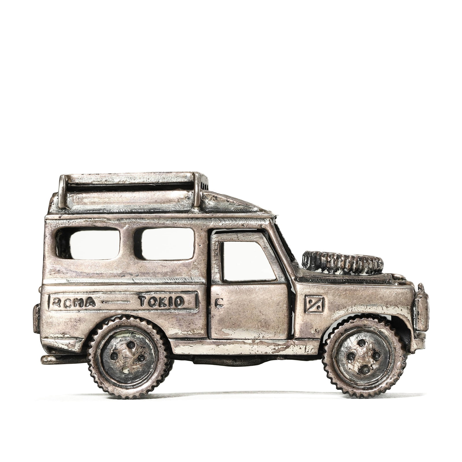 VINTAGE STERLING SILVER LAND ROVER MODEL: Dimensions: Length: 2 7/8 in. (7.3 cm), Width: 1 1/8 in. (2.8 cm), Height: 1 3/4 in. (4.5 cm), Weight: 3.6 oz (102.8 g). Description: A finely detailed sterling silver miniature model of a classic