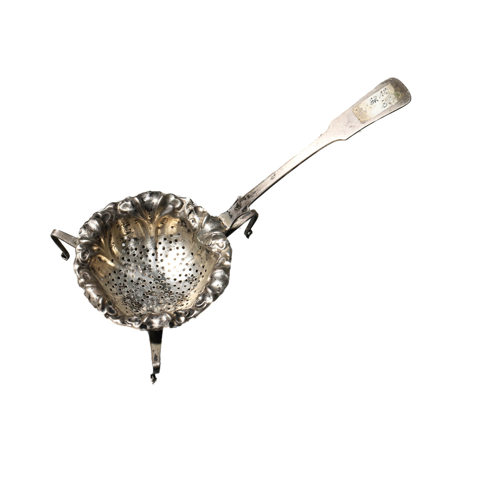 AN ENGLISH SILVER TEA STRAINER, 19TH CENTURY: Dimensions Length 6 1/2 in. (16.5 cm), Height 3 1/8 in. (8 cm), Bowl depth 7/8 in. (2.3 cm); Weight 35.5 g Description A finely crafted silver tea strainer with scalloped repoussé bowl, pierced with