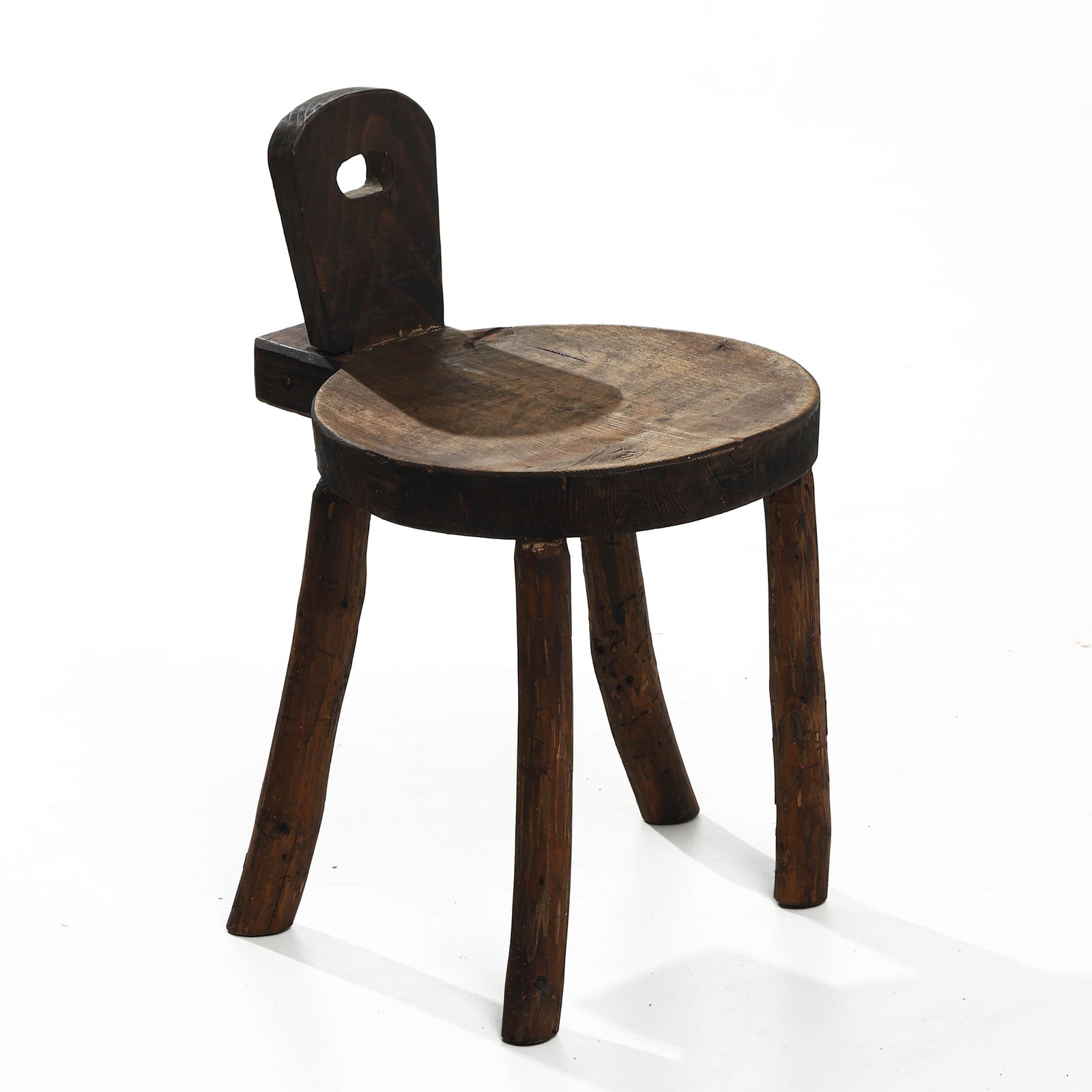 FRENCH PRIMITIVE OAK STOOL, 1950: Dimensions: Height 20 1/2 in. (52 cm), Seat height 13 3/4 in. (35 cm), Width 12 5/8 in. (32 cm) Description A rustic French primitive stool crafted in solid oak circa 1950, showcasing the robust