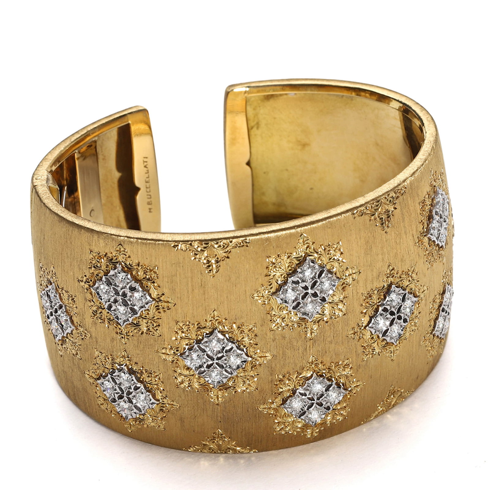 BUCCELLATI GOLD CUFF BRACELET WITH DIAMOND PANELS: Dimensions: Inner Diameter: 2 5/16 in. (5.9 cm), Weight: 96.6 g Description: A luxurious open cuff bracelet by Buccellati, masterfully constructed in yellow gold and decorated with an array of