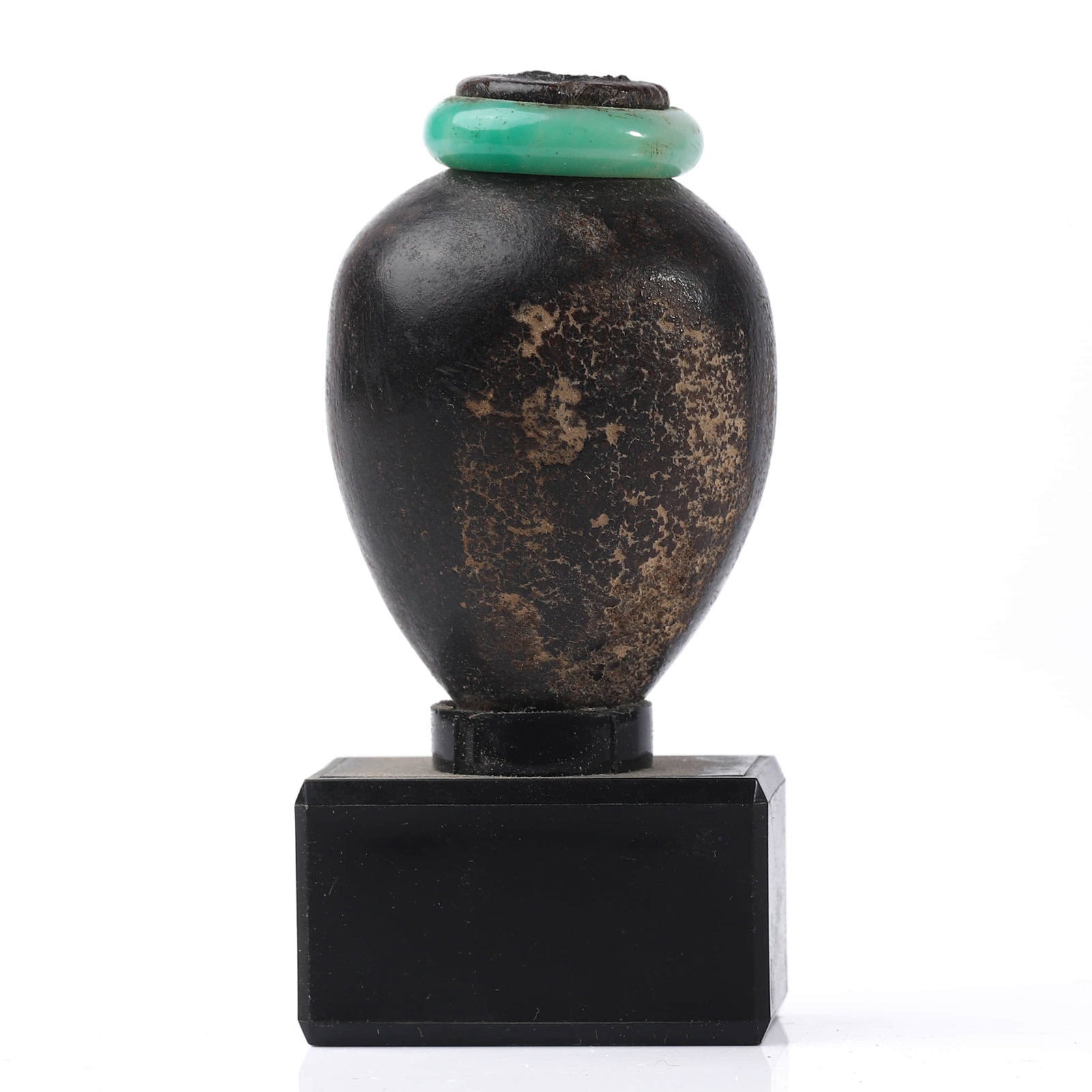 A SMALL BLACK GLAZED VESSEL WITH TURQUOISE-COLORED RING, MOUNTED AS A DISPLAY STAMP: Dimensions Height: 3 in (7.5 cm) Description A small, ovoid black-glazed vessel showing areas of natural wear and age patina, now adapted as a decorative stamp or desk object. The mouth is fitted
