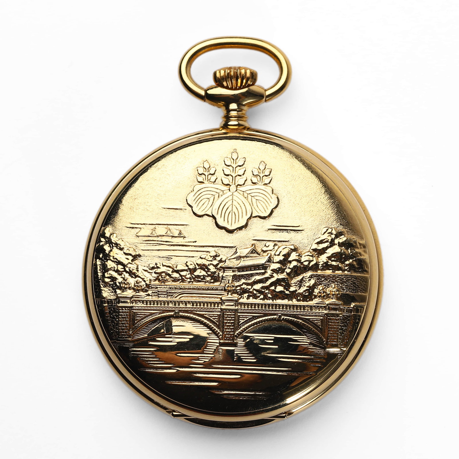 JAPANESE IMPERIAL PALACE COMMEMORATIVE HUNTER-CASE POCKET WATCH: Dimensions Dial diameter 1 7/8 in. (47.2 mm); Weight 82.1 g Description: A gold-tone hunter-case pocket watch featuring a finely engraved front cover depicting the iconic Nijubashi Bridge and the
