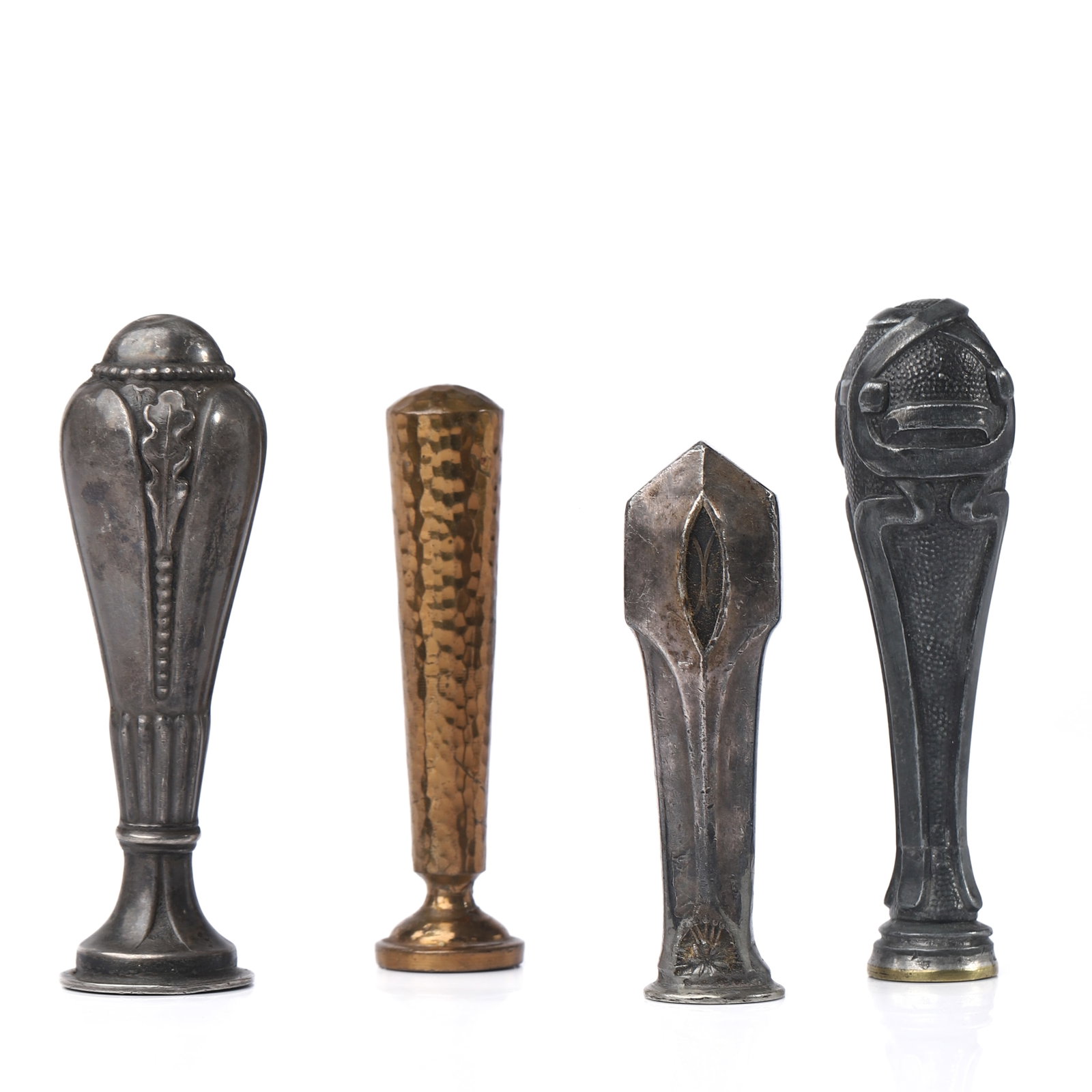 A GROUP OF FOUR METAL WAX SEAL STAMPS: Dimensions: Tallest: 3 1/4 in (8.2 cm) Shortest: 2 5/8 in (6.6 cm) Total weight: 284.8 g Description: A set of four antique metal wax seal stamps in mixed materials and finishes, featuring hand-crafte
