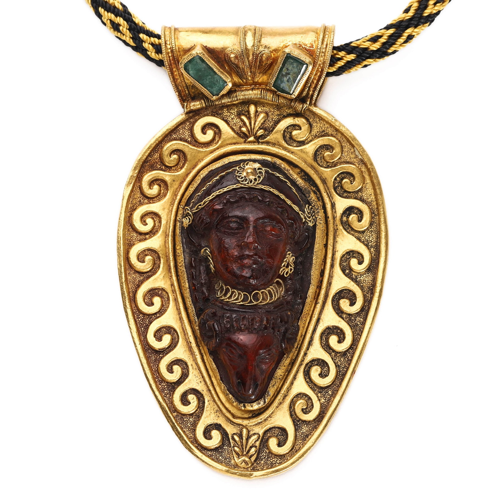 GOLD AND AMBER PENDANT WITH FEMALE BUST: Dimensions: Height: 3 3/8 in. (8.6 cm) Width: 2 in. (5.1 cm) Weight: 20 g Description & Analysis: This striking pendant features a deeply carved amber bust of a female figure set within an ornate