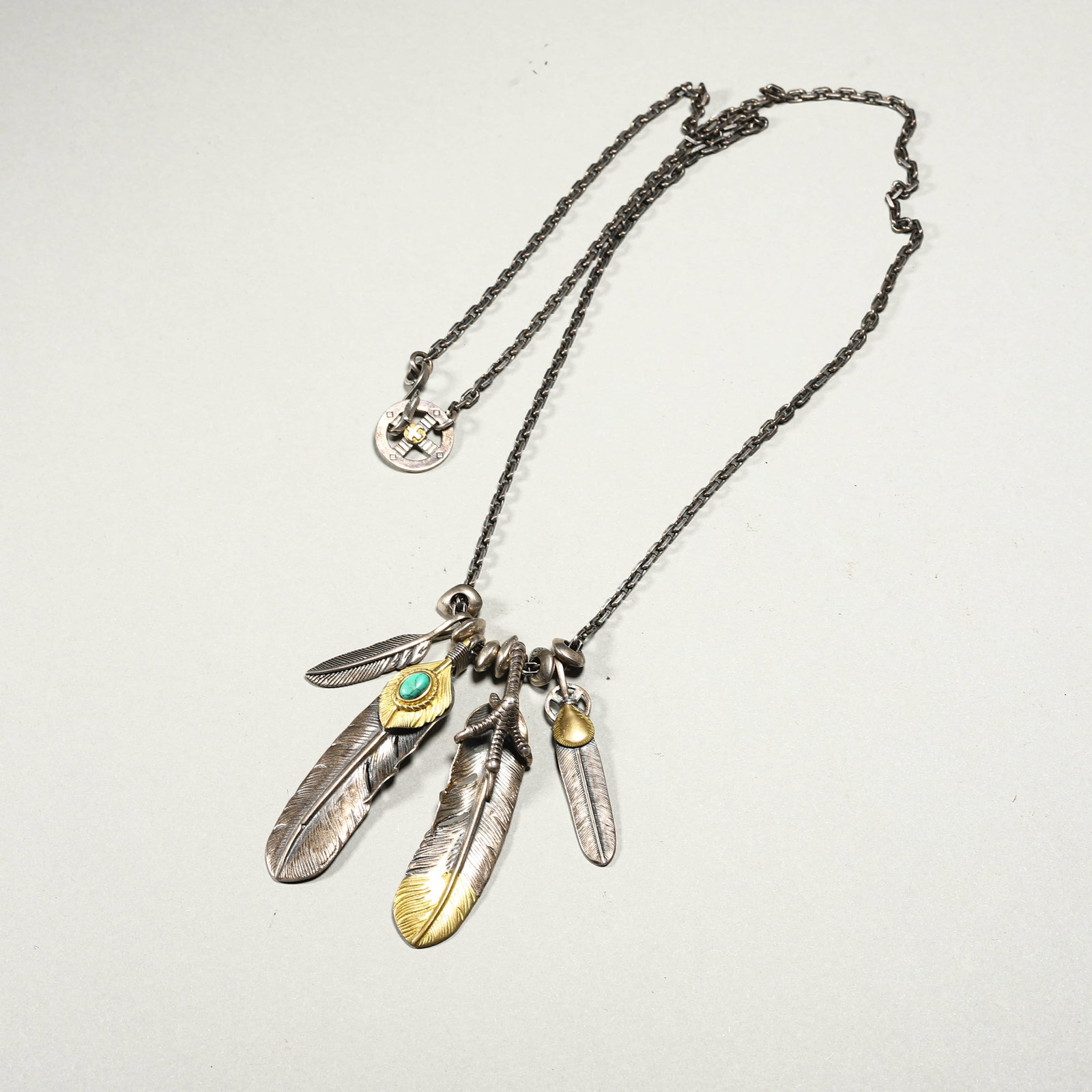STERLING SILVER FEATHER NECKLACE WITH TURQUOISE AND GILT ACCENTS: STERLING SILVER FEATHER NECKLACE WITH TURQUOISE AND GILT ACCENTS