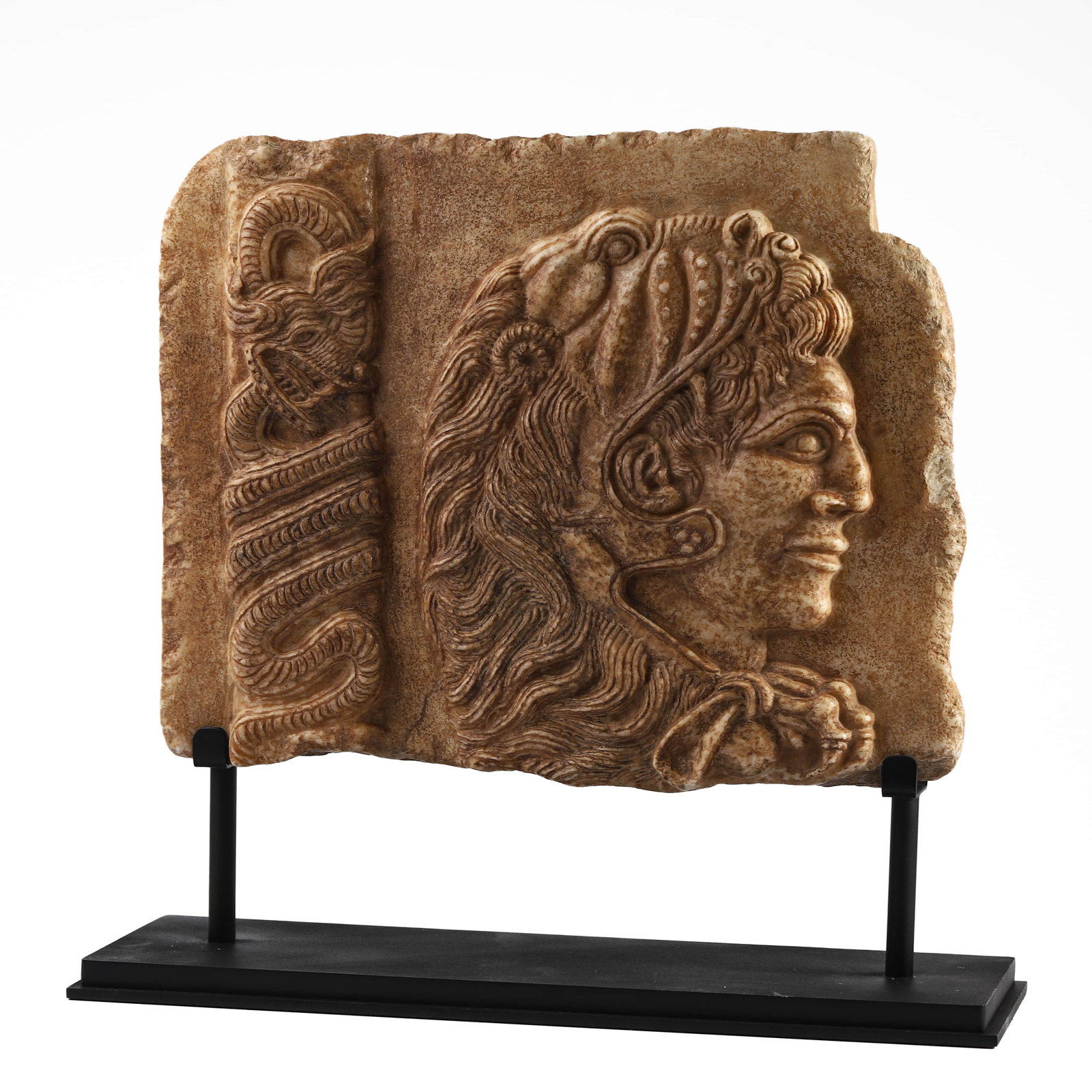 A CARVED STONE RELIEF PANEL: Dimensions Length 13 3/4 in (35 cm); Width 11 1/4 in (28.5 cm); Thickness 2 in (5 cm) Descriptio This rectangular stone relief panel depicts a finely carved male profile, rendered in high relief with 