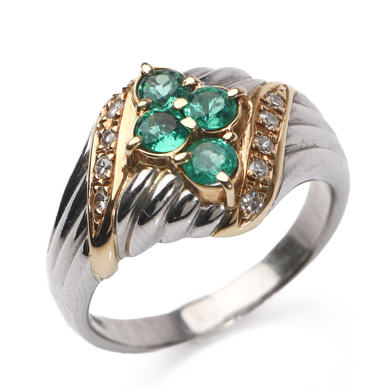 RETRO PERIOD PLATINUM AND 18K TWO-TONE GOLD EMERALD AND DIAMOND RING: Dimensions Inner diameter: 11/16 in. (18.3 mm); Weight: 11.7 g. Description A Retro period platinum and 18k yellow gold two-tone ring featuring a floral arrangement of round-cut emeralds weighing