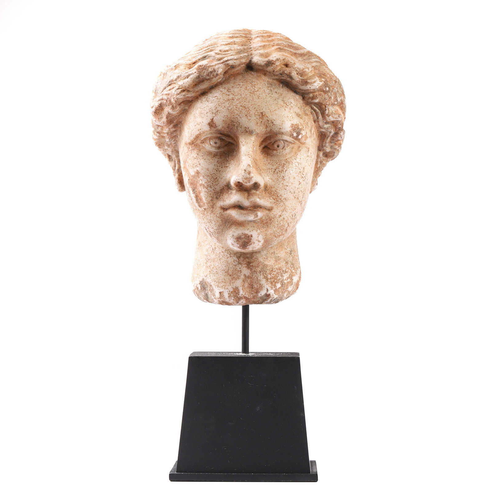 A MARBLE HEAD OF A FEMALE FIGURE: Dimensions: Total height: 14 3/8 in. (36.5 cm), height without stand: 9 in. (23 cm) Description:?This finely carved marble head represents a serene female figure, possibly a goddess or muse, with deli