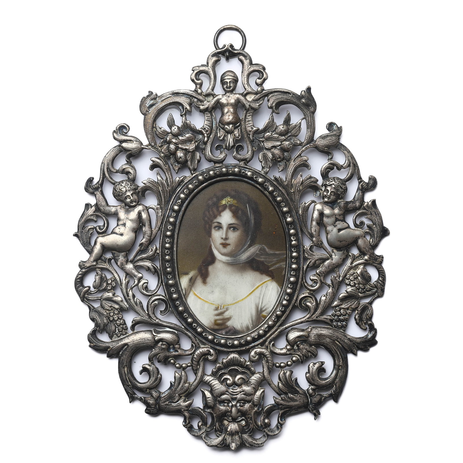 SILVER FRAMED PORTRAIT MINIATURE WITH CHERUB AND FOLIATE DECORATION: Overall size: 7 1/8 × 5 5/16 in. (18 × 13.5 cm) Description This finely executed decorative portrait miniature is set within an elaborate silver openwork frame, richly cast with scrolling foliate