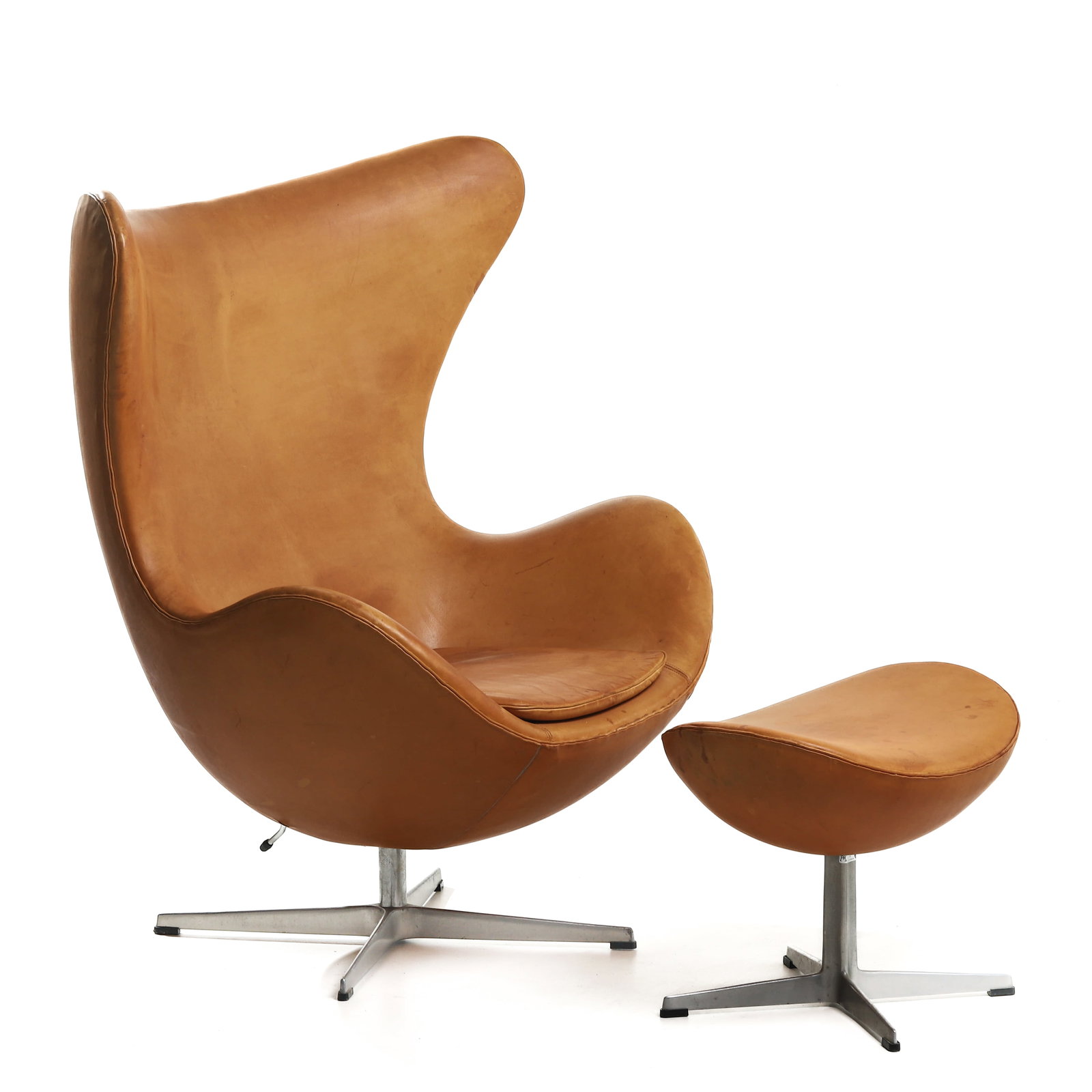 ARNE JACOBSEN "EGG" CHAIR AND OTTOMAN, FIRST GENERATION, FOR FRITZ HANSEN, 1959: Dimensions Chair: Height 42 1/2 in. (108 cm), Seat height 15 3/4 in. (40 cm), Width 36 5/8 in. (93 cm); Ottoman: Length 21 5/8 in. (55 cm), Width 15 3/4 in. (40 cm), Height 16 1/2 in. (42 cm)