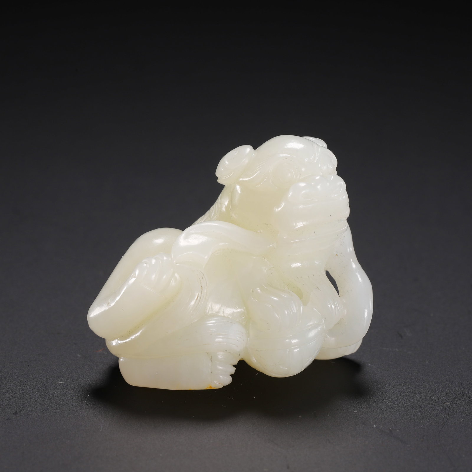 Hetian jade lion playing with an embroidered ball: Length 4cm, Width 2.5cm, Height 3cm