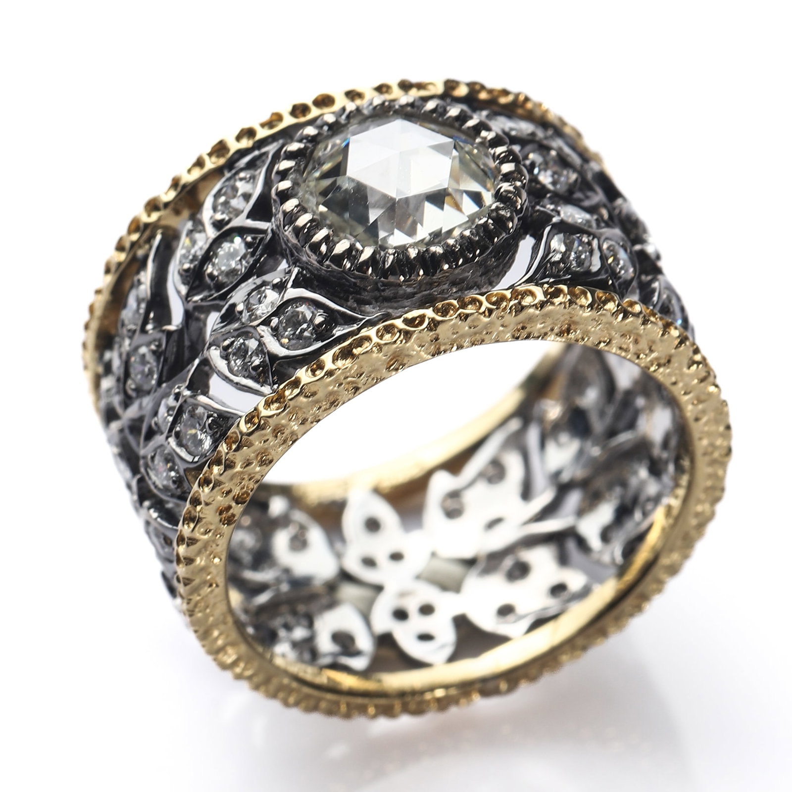 BUCCELLATI-TWO-TONE-18K-GOLD-AND-DIAMOND-OPENWORK-RING: Dimensions Interior Diameter 11/16 in.(17 mm) Weight 9.2g Description A finely crafted Buccellati two-tone 18K gold and diamond ring, designed with an elaborate pierced foliate motif in white gold