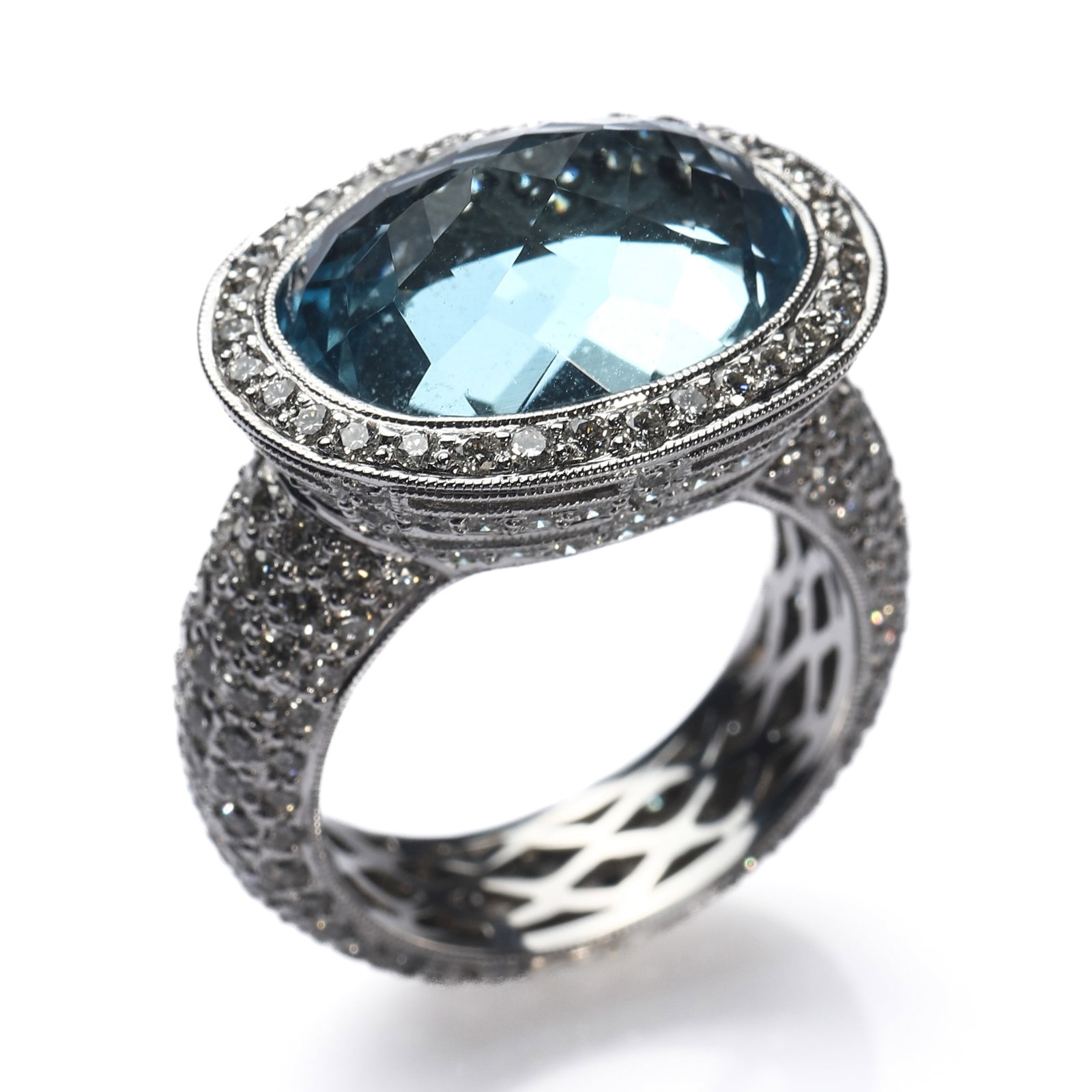 18K-WHITE-GOLD,-AQUAMARINE-AND-DIAMOND-COCKTAIL-RING: Dimensions Inner Diameter 5/8in. (16.8 mm) Weight 12.4g Description A substantial 18K white gold cocktail ring centered with a large oval faceted blue gemstone, likely aquamarine, surrounded by a