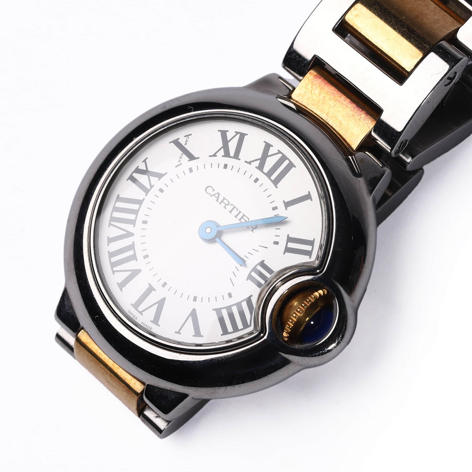 CARTIER-BALLON-BLEU-TWO-TONE-STAINLESS-STEEL-AND-GOLD-LADY'S-WRISTWATCH: Diameter: 29.7 mm A Cartier Ballon Bleu wristwatch, featuring a round case in stainless steel and yellow gold, with signature integrated crown set with a blue cabochon. The silvered guilloché dial is