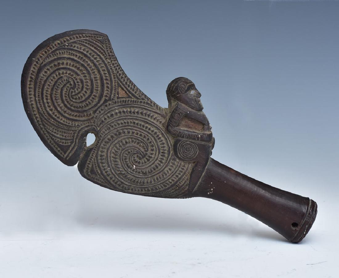 Maori Carved Patu Wahaika: one piece of hardwood, comprising flat carved blade and carved male figure with abalone decoration 11 3/4" long 19th century