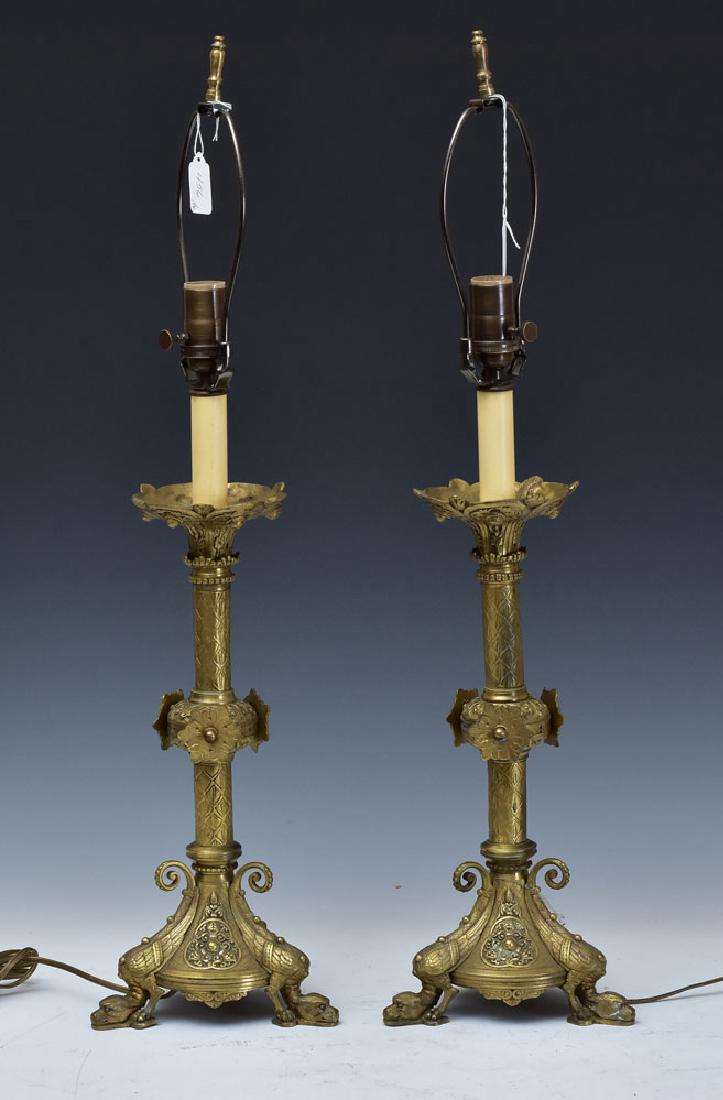 Pair of Gothic Style Bronze Candlestick Lamps: with winged griffin feet, 28" high overall late 19th century