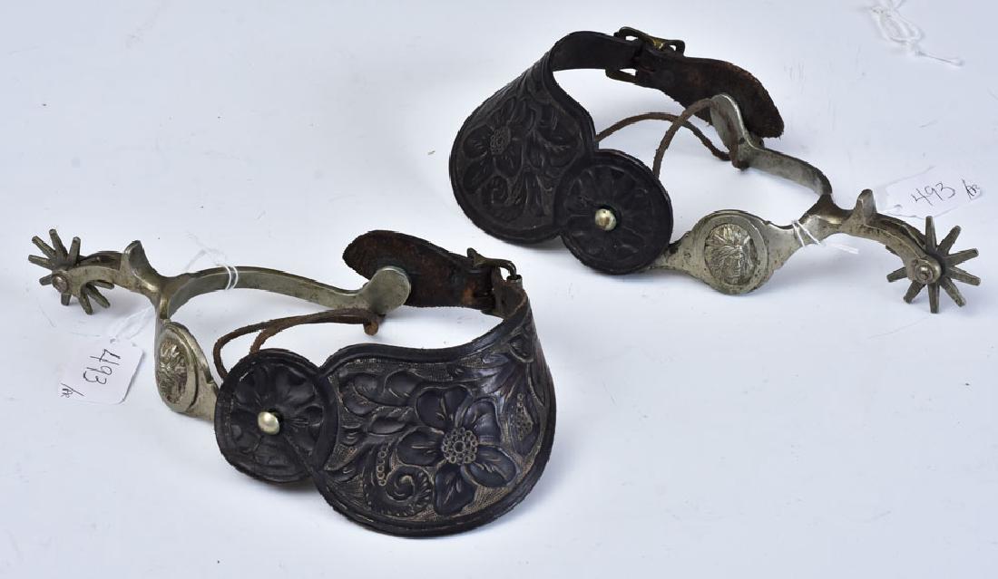 Pair of Western Spurs: with Native American masks and tooled leather