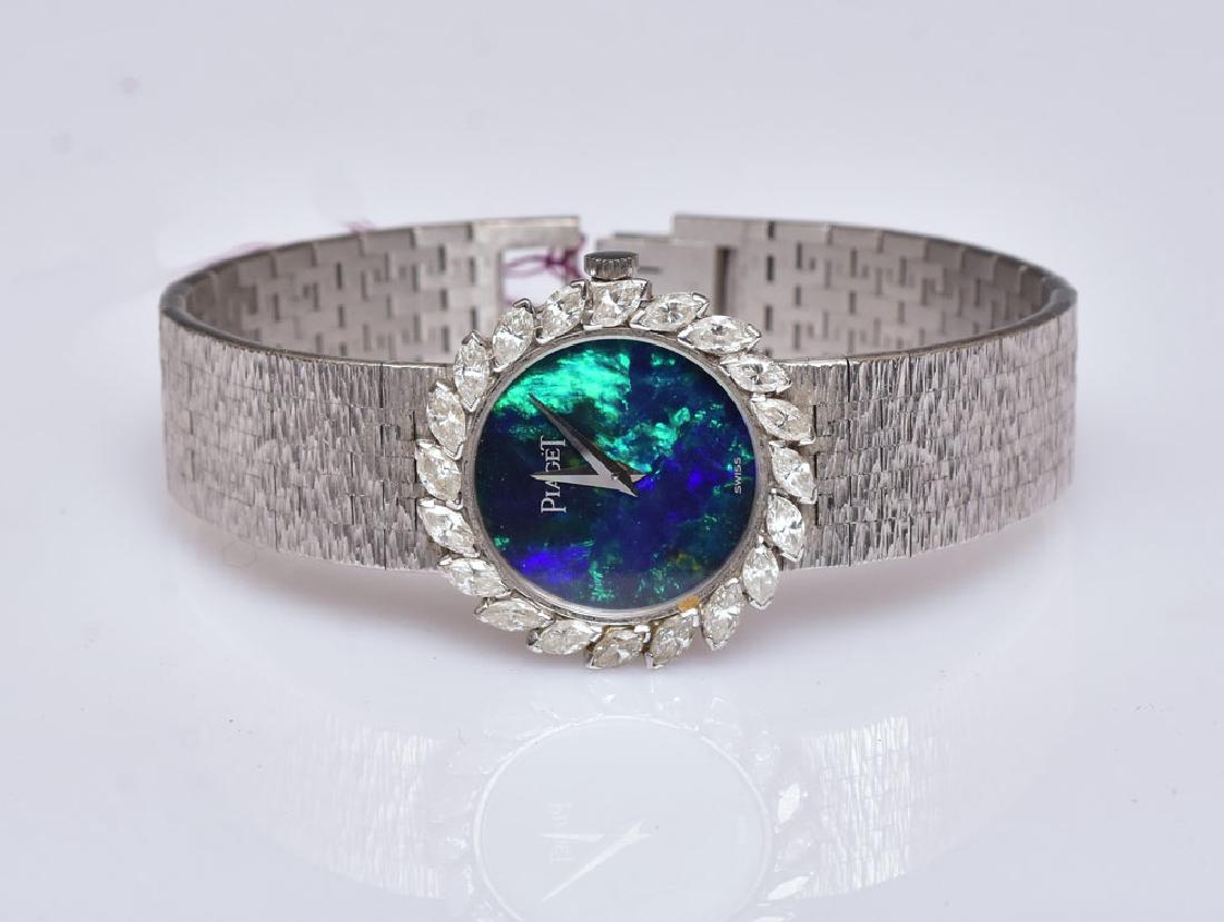Piaget 18k Gold Ladies Wrist Watch: black opal face surrounded by diamonds 3/4" diameter face, 6 1/2" bracelet 30.5 dwt gross