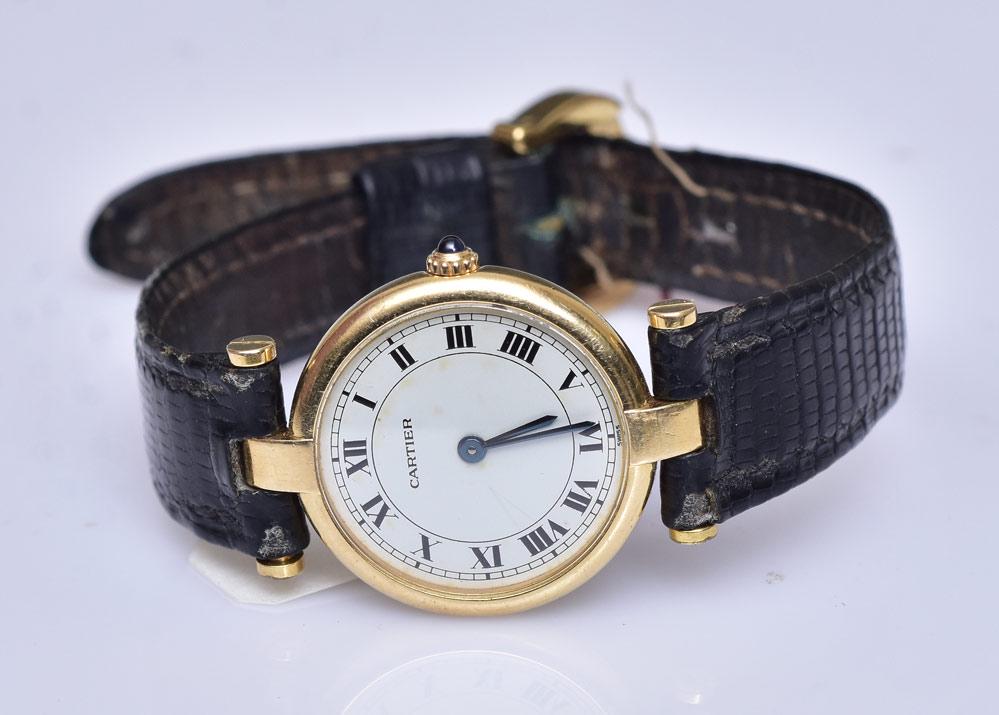 Cartier 18k Gold Ladies Wrist Watch: 7/8" diameter case quartz movement on a replaced leather band with Cartier certificate