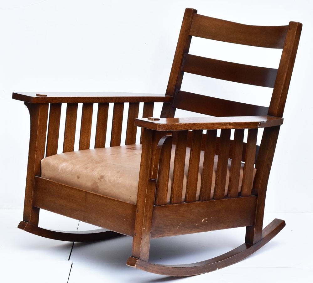 L & J G Stickley Rocking Chair: slat sides with leather cushions 35" high, 32" wide, 28" deep has portion of the original decal early 20th century
