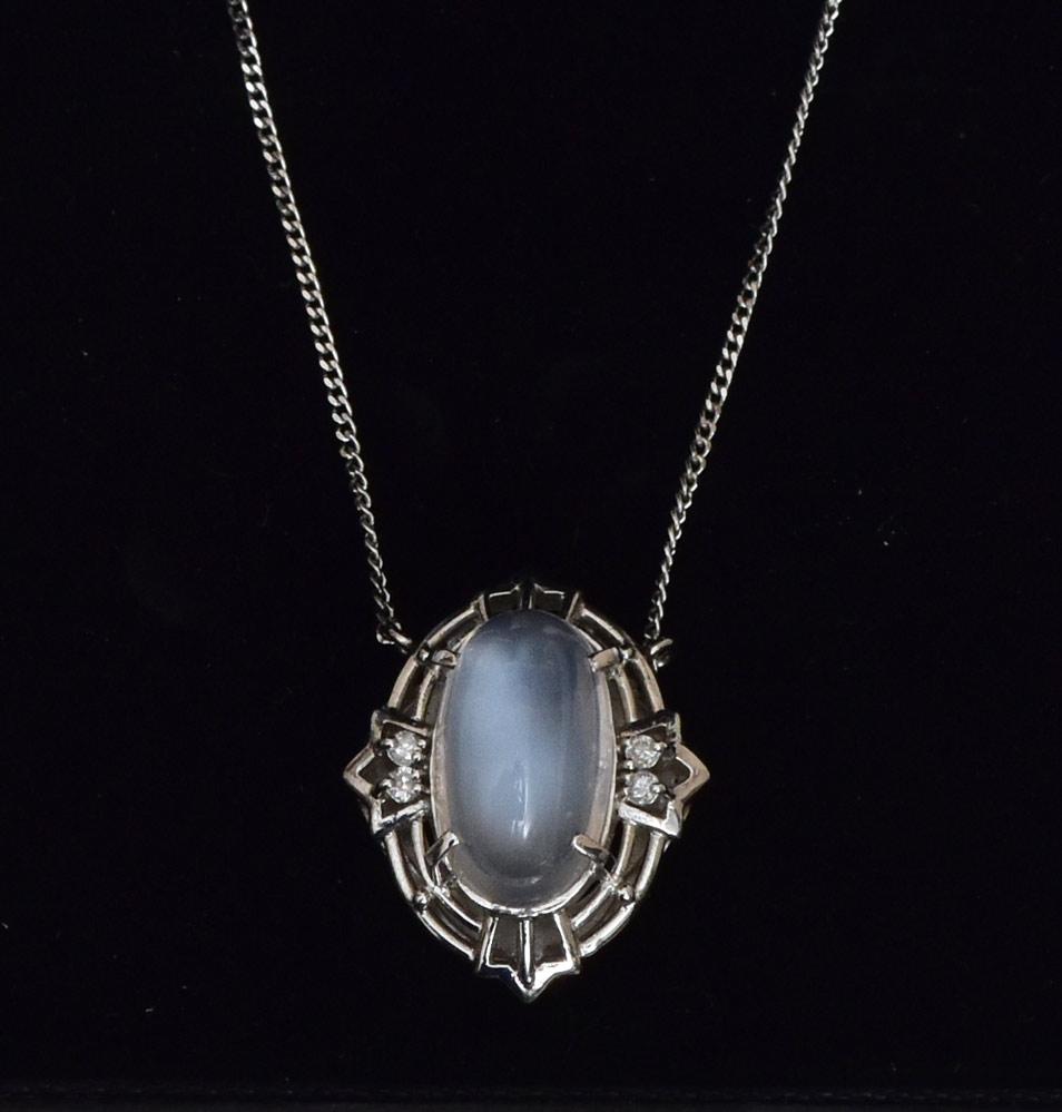 Platinum Moonstone Pendant: set with diamonds, 5/8" long on a platinum 15" long chain 4.2 dwt gross