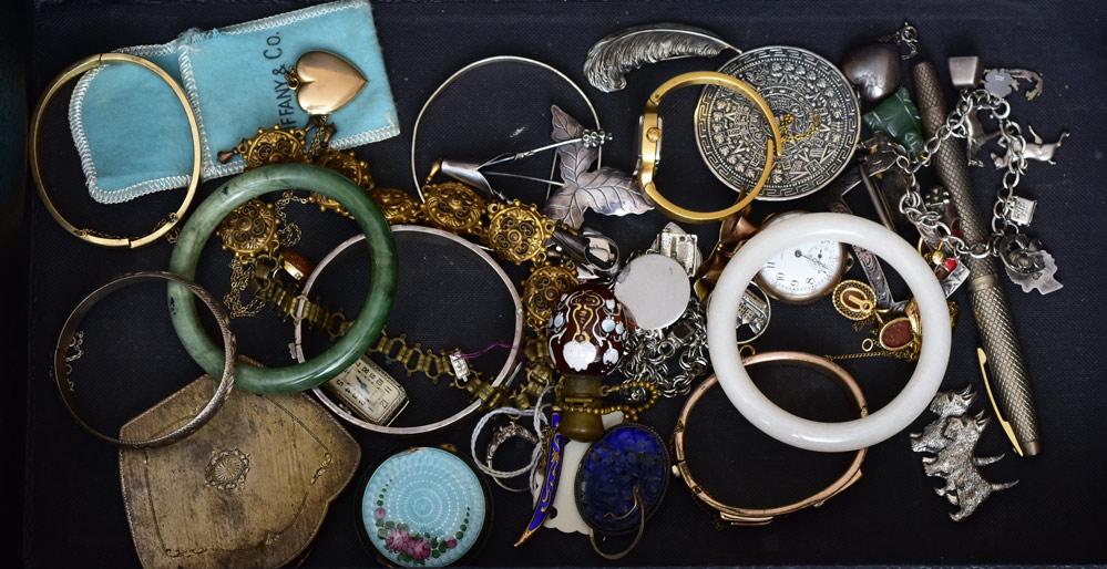 Group of Jewelry: including two jade bracelets, carved lapis brooch, .800 silver compact, gold filled watches, three sterling silver charm bracelets, glass perfume, Tiffany & Co. sterling silver heart pendant, sterling