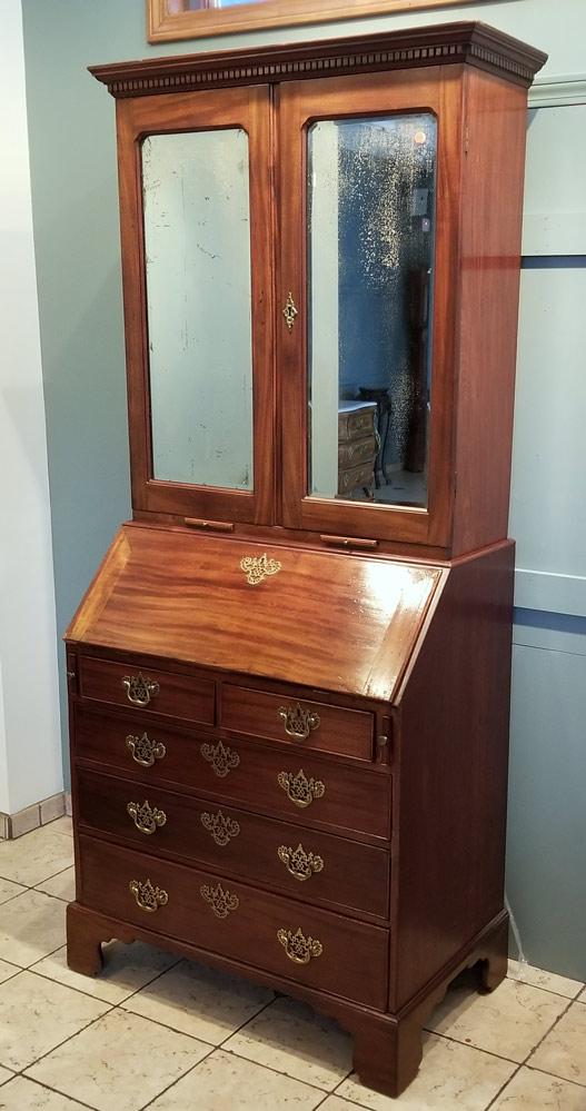 George III Mahogany Secretary Desk: with bookcase top, candle slides and dentil moldings 85" high, 36" wide late 18th century