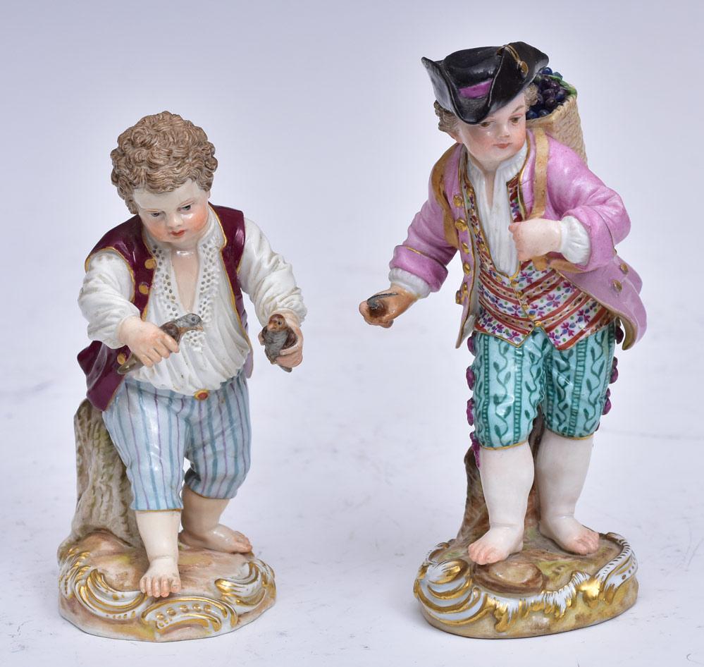 Two Meissen Porcelain Figures: Boy with Birds, Boy with Grape Basket 5 1/2" and 4 3/4" high with crossed sword Meissen marks