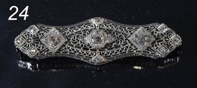 DIAMOND AND 14KT WHITE GOLD AND PLATINUM BROACH wit: DIAMOND AND 14KT WHITE GOLD AND PLATINUM BROACH with three central mine cut diamonds, each about .70 ct, total weight approx. 2.6cts 55mm, circa 1920