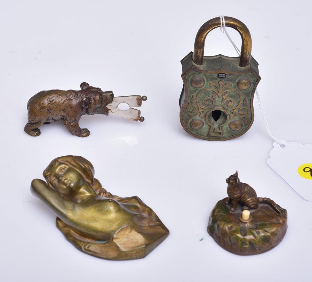 Novelty Cigar Cutters and Electric Bell Switches: cigar cutter in the form of a lock, 4 1/4" long a bronze bear with cigar cutter extending from his mouth, a cat switch and a reclining nude switch with nipple button, signed Titre, 4" long