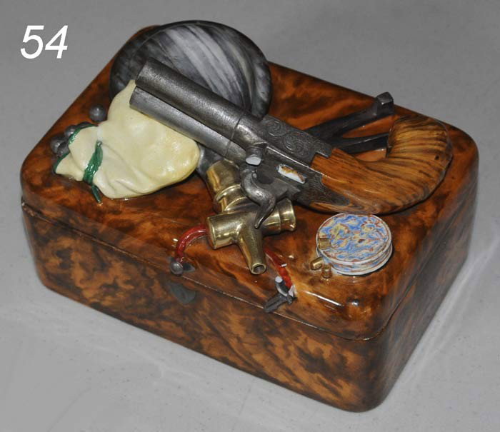 AUSTRIAN CERAMIC HUMIDOR with faux pistol, powder f: AUSTRIAN CERAMIC HUMIDOR with faux pistol, powder flask, etc on lid, 7 1/2"x5"x5", circa 1900 Shipping Information: Shipping within the Continental USA (excluding insurance) $30