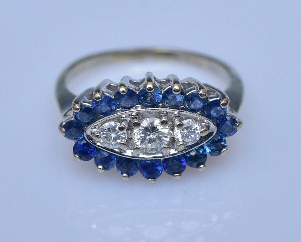 14k Gold Diamond and Sapphire Ring: three diamonds, approximately .35 ct tw surrounded by sapphires, ring size 5 3/4, weight is 2.3 dwt gross