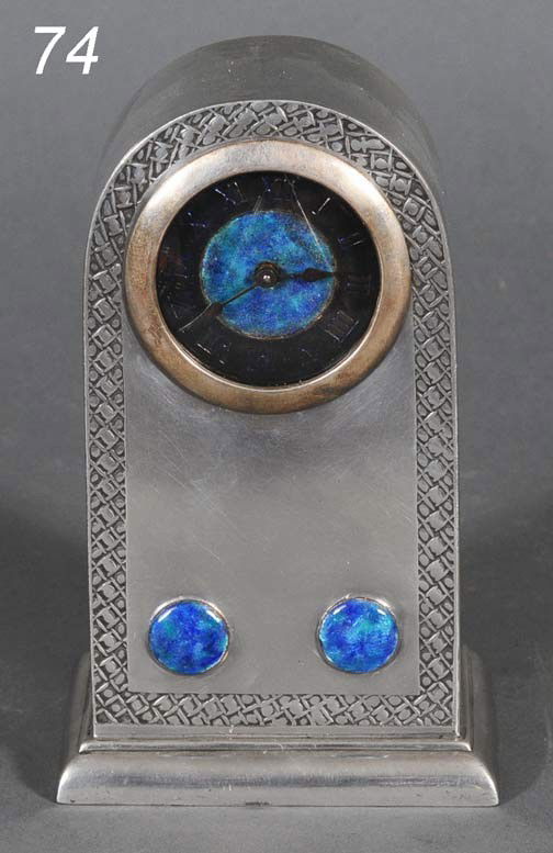 LIBERTY & COMPANY PEWTER CLOCK designed by Archibal: LIBERTY & COMPANY PEWTER CLOCK designed by Archibald Knox with blue enameled face and applications 6 1/2" high circa 1905, stamped " English Pewter made by Liberty & Co 01151" Shipping Information: Pa