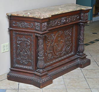 attributed to Alexander Roux: Carved Oak Credenza the door with a Maiden holding a basket of fruit, lion head drawer handle, rouge marble top, 53 1/2" x 19", 36" high, late 19th century