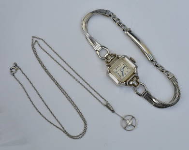 14k Gold Bulova Diamond Ladies Wrist Watch and Diamond Pendant: watch case, 16mm, manual winding set with six diamonds on a stainless bracelet together with a 14k gold diamond pendant, approximately .20 ct diamond on a 14" long chain, 1.7 dwt gross